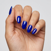 Hand with blue nail polish on a plain background